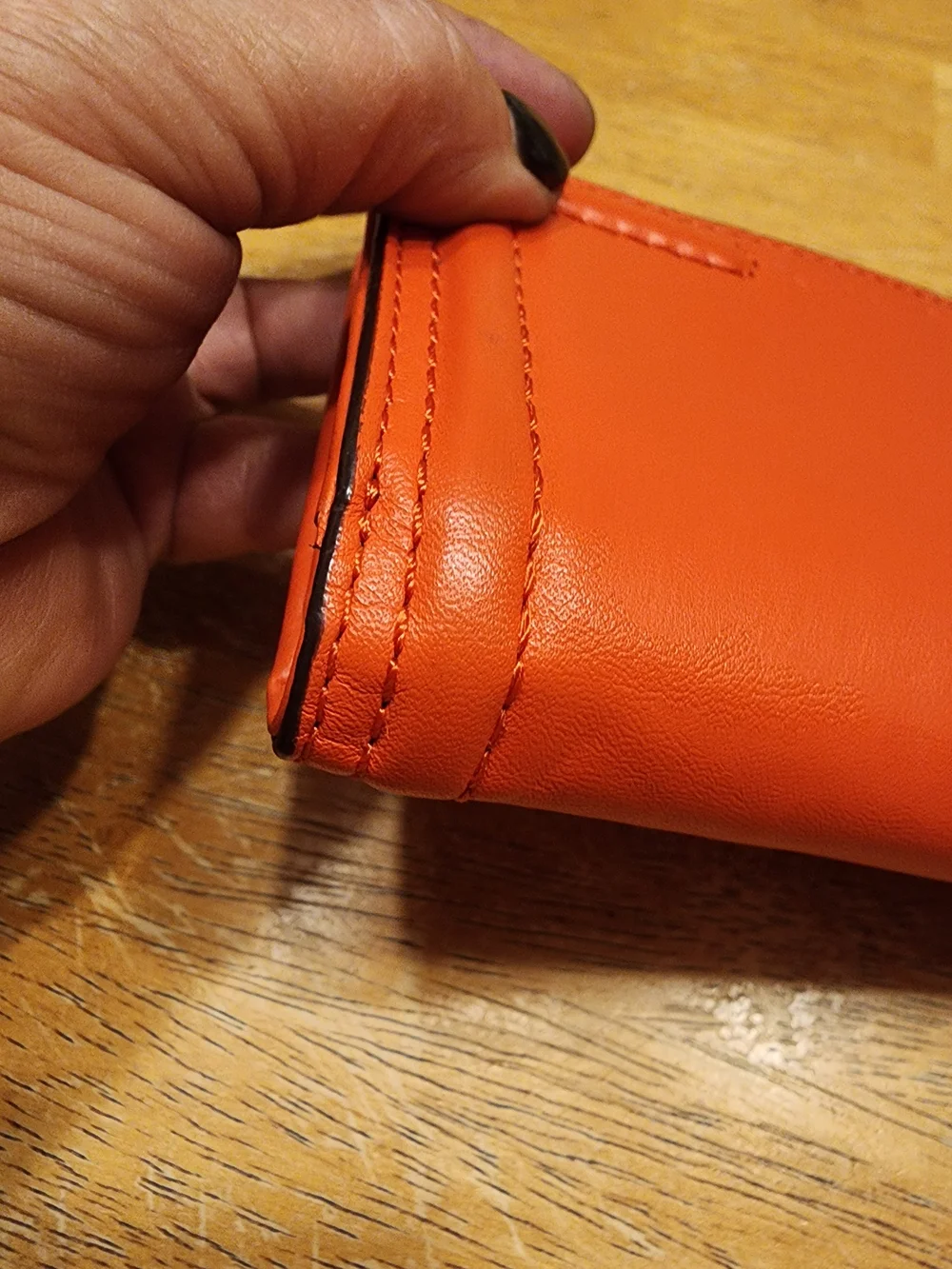 Coach Campbell Leather Buckle Medium Wallet in a vibrant orange shade with brass